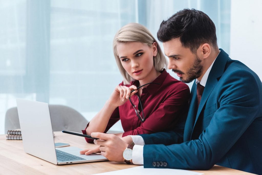 woman and man looking at stocks