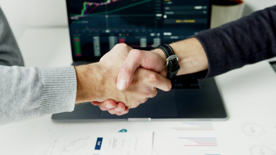 hand-shake-over-stocks