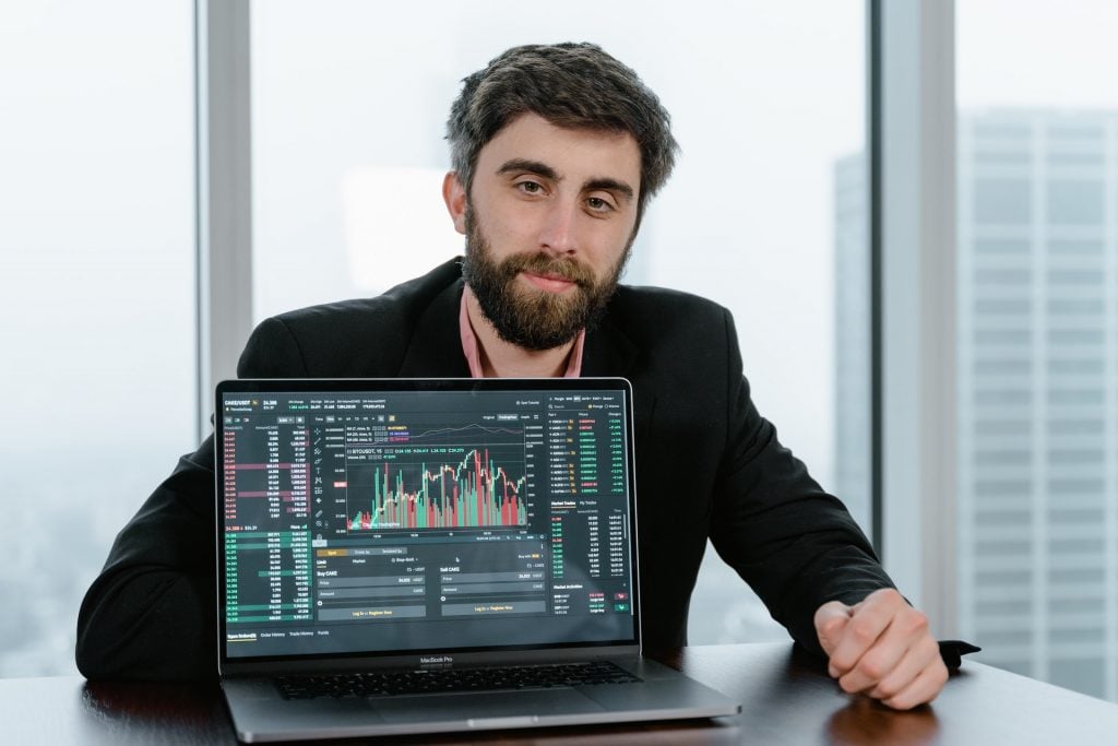 man on laptop investing with dividend stocks
